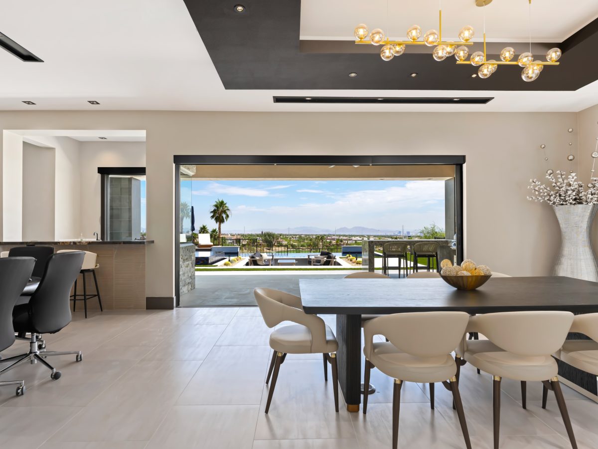 Custom wine niche with modern metal shelving, mirrored panels, and hidden LED lighting — Reveal Interior Design Las Vegas