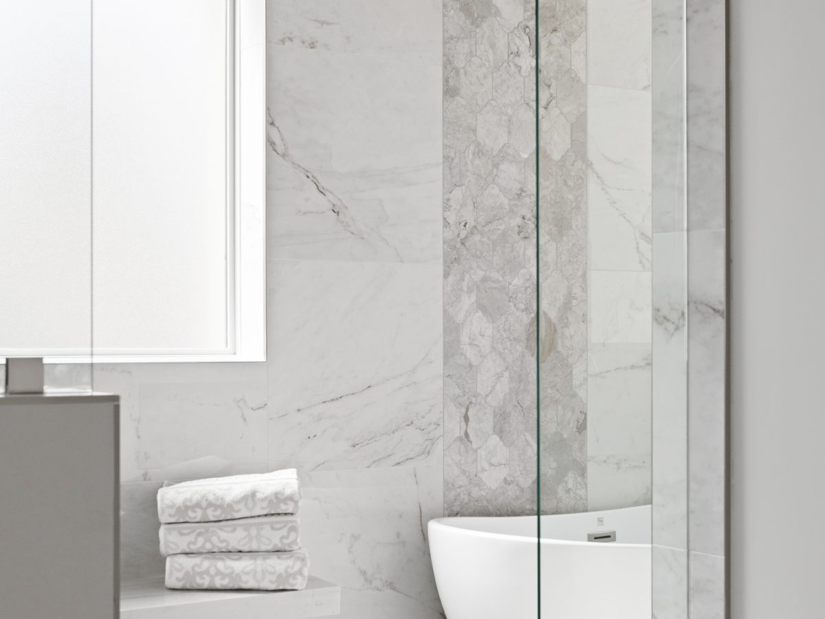 Transitional primary bathroom wet room with marble-look porcelain tile and freestanding tub — Reveal Interior Design Las Vegas