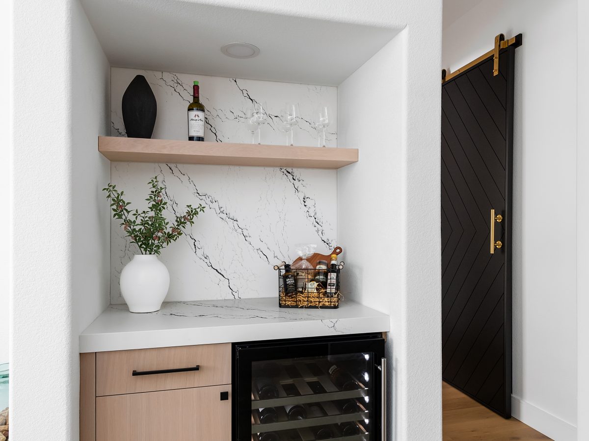 Built-in home bar with black-veined white quartz and whitewashed oak cabinetry — Reveal Interior Design Las Vegas