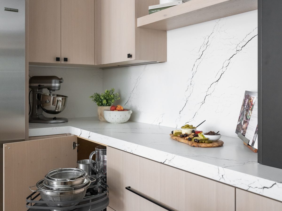 Contemporary kitchen with white-washed oak cabinetry, black-veined white quartz countertops and backsplash — Reveal Interior Design Las Vegas