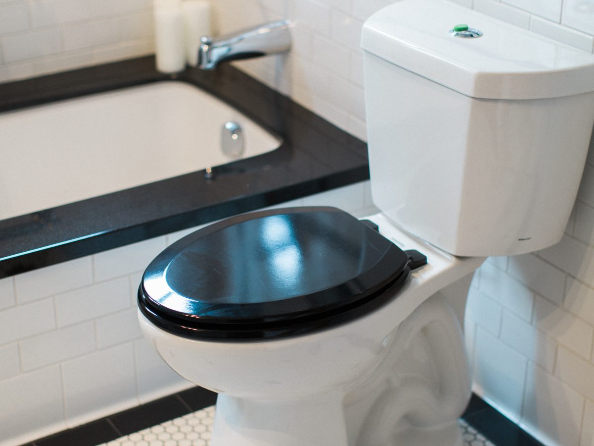 Art Deco bathroom with black-and-white hex mosaic floor and white subway tile — Reveal Interior Design Las Vegas