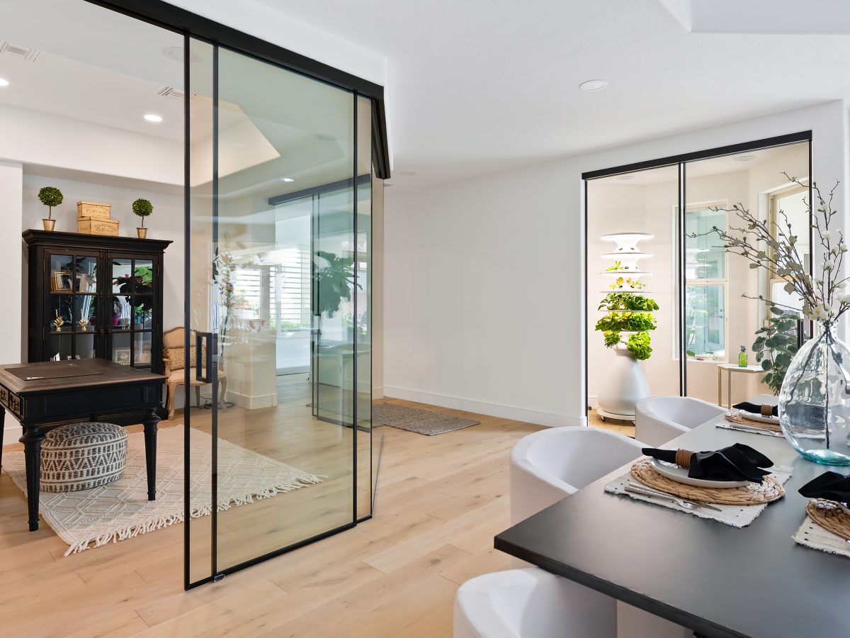 Glass-walled home office with black metal framing and oak engineered flooring — Reveal Interior Design Las Vegas