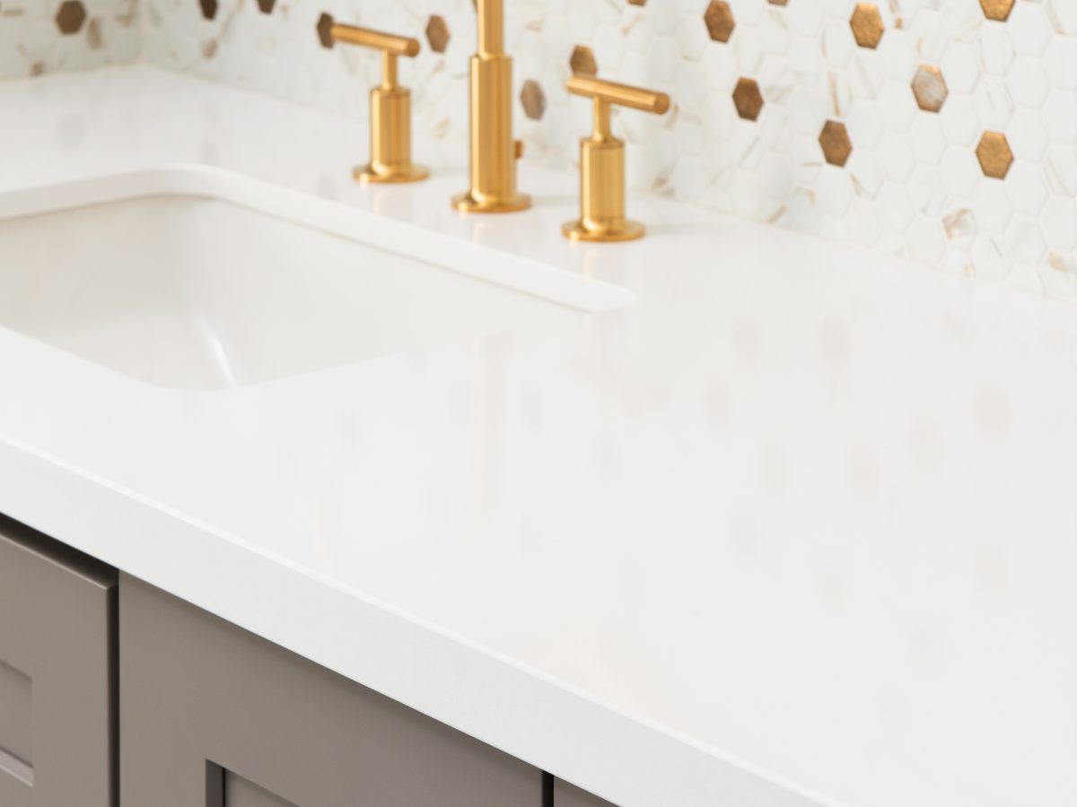 Primary bathroom vanity with calacatta-look mosaic tile backsplash and brushed gold fixtures — Reveal Interior Design Las Vegas