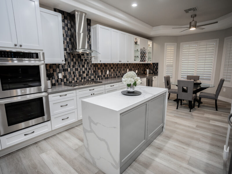 Contemporary waterfall island kitchen design Las Vegas — Reveal Interior Design