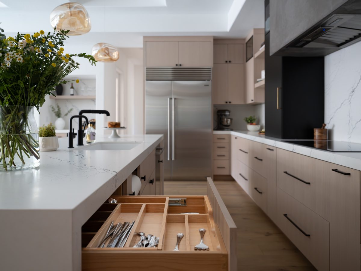 Contemporary kitchen with white-washed oak cabinetry, black-veined white quartz countertops, and matte black accents — Reveal Interior Design Las Vegas