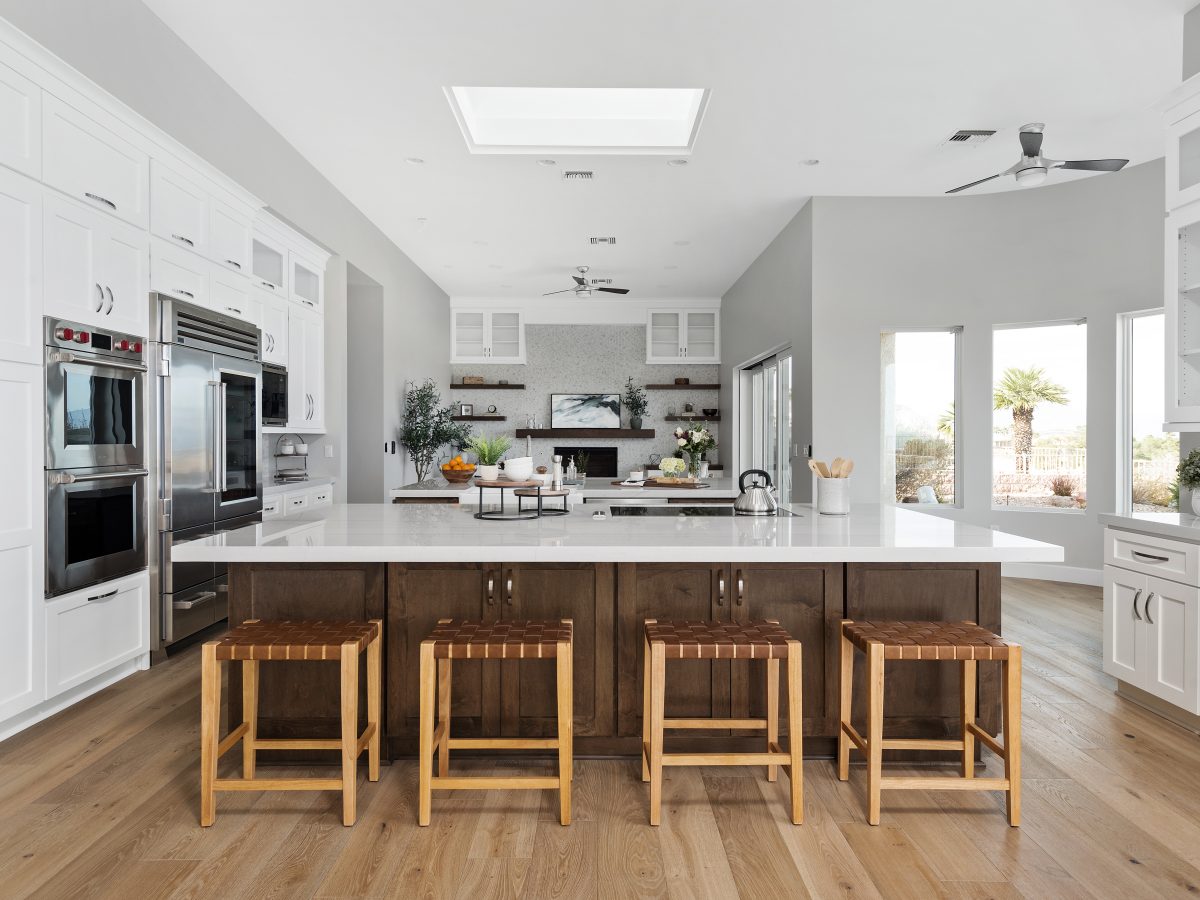 Transitional kitchen with Taj Mahal quartzite island, dark stained maple and off-white shaker cabinetry — Reveal Interior Design Las Vegas