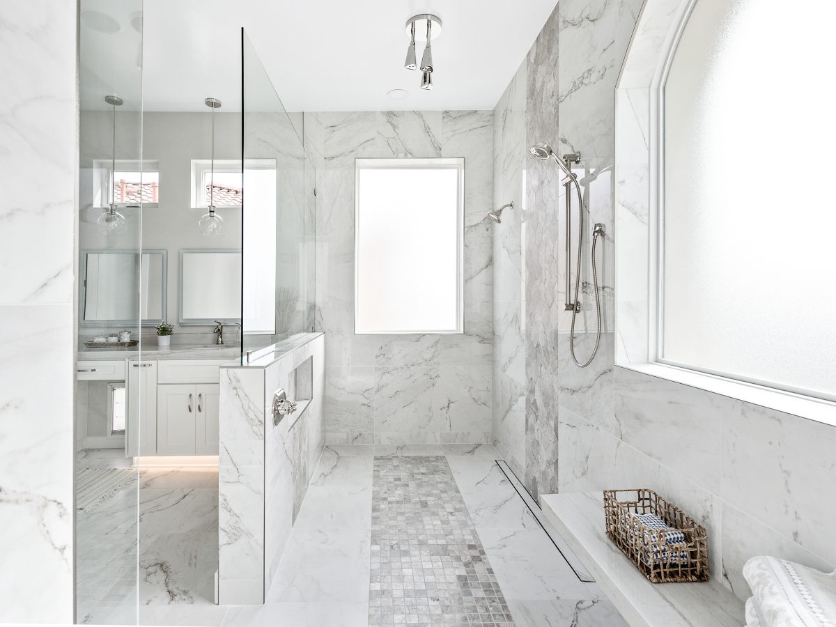 Transitional primary bathroom wet room with Taj Mahal quartzite and marble-look porcelain tile — Reveal Interior Design Las Vegas