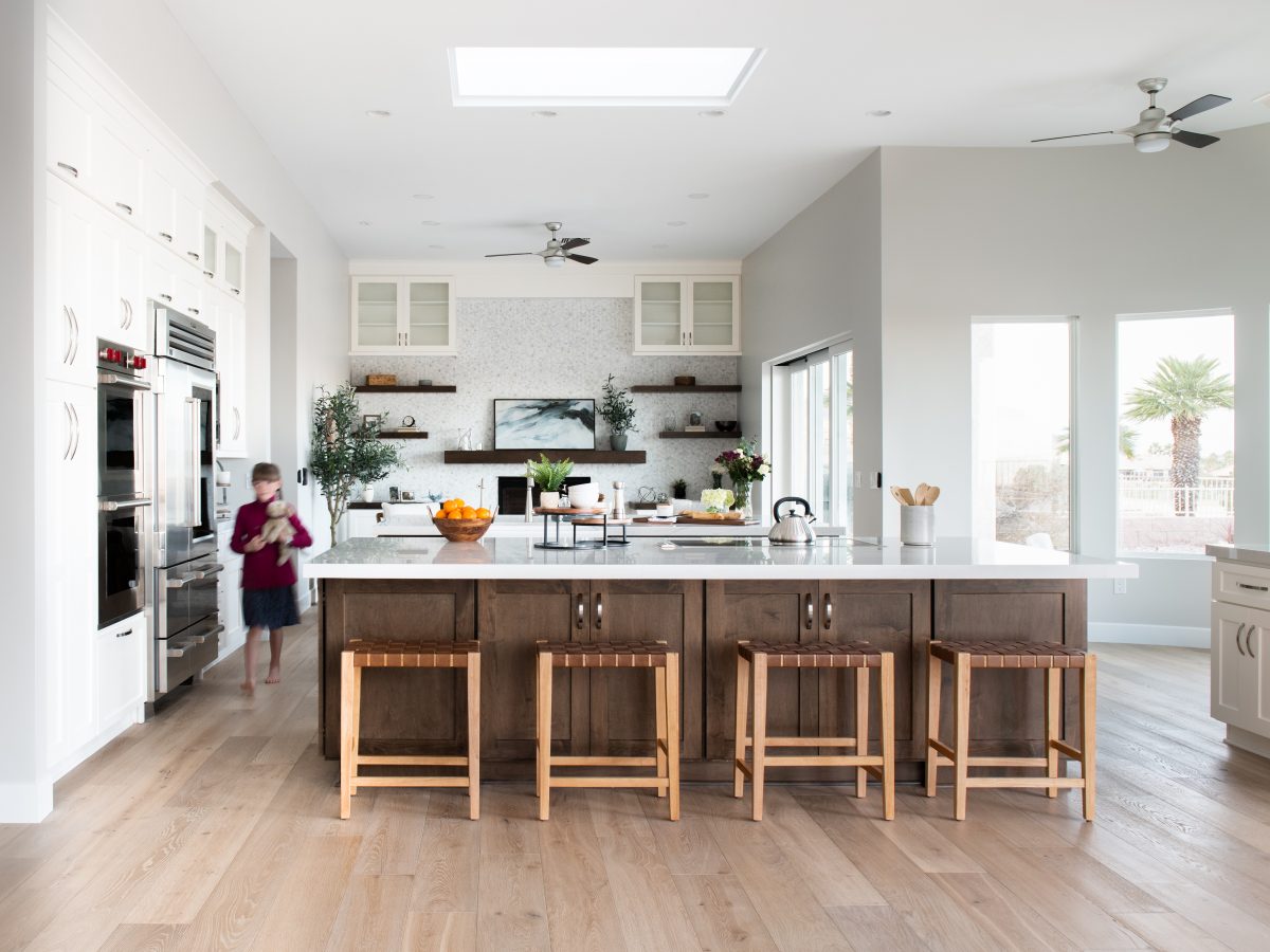 Transitional kitchen with Taj Mahal quartzite island, dark stained maple and off-white cabinetry — Reveal Interior Design Las Vegas