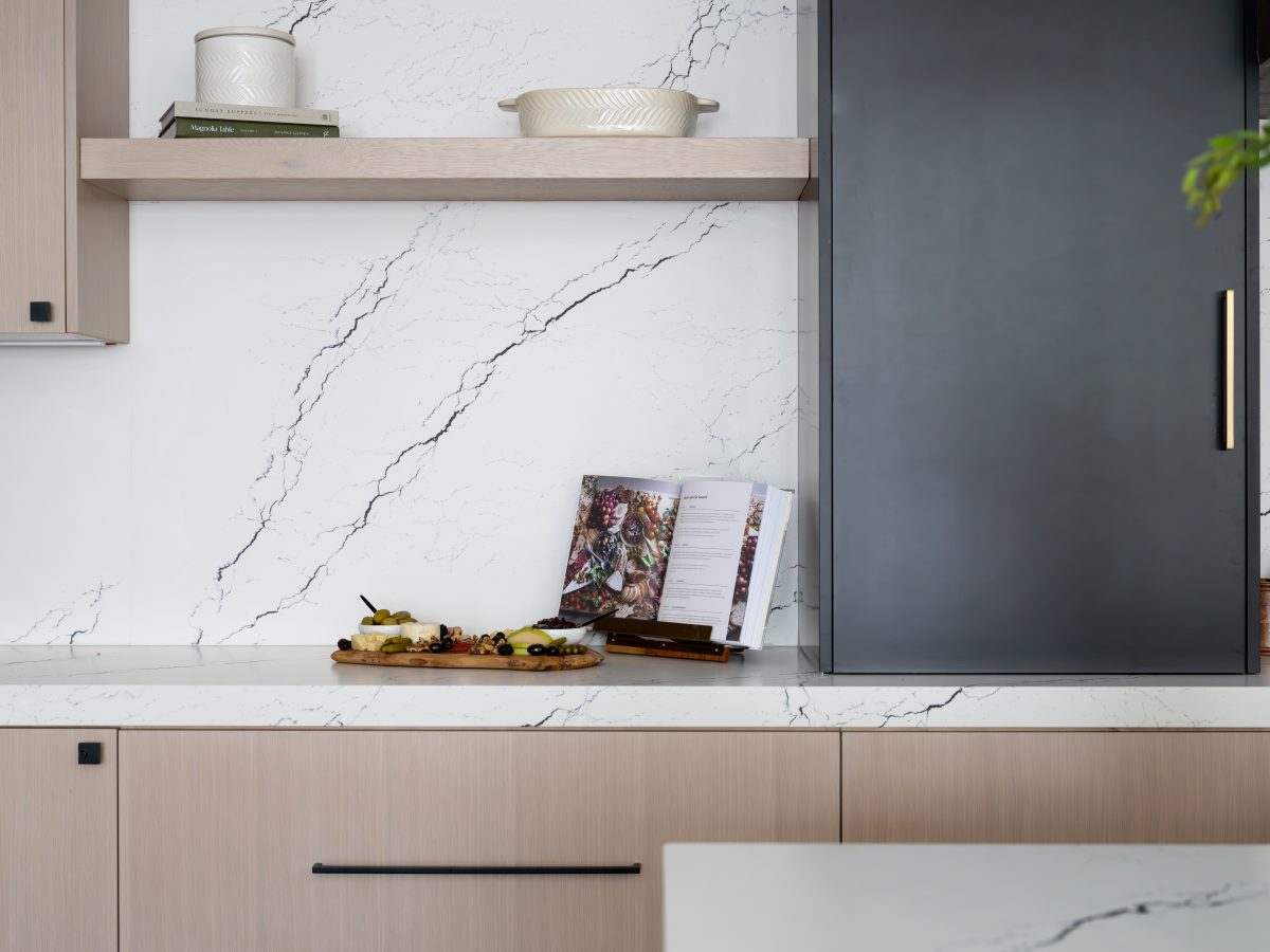 Kitchen with black-veined white quartz countertops and whitewashed oak cabinetry — Reveal Interior Design Las Vegas
