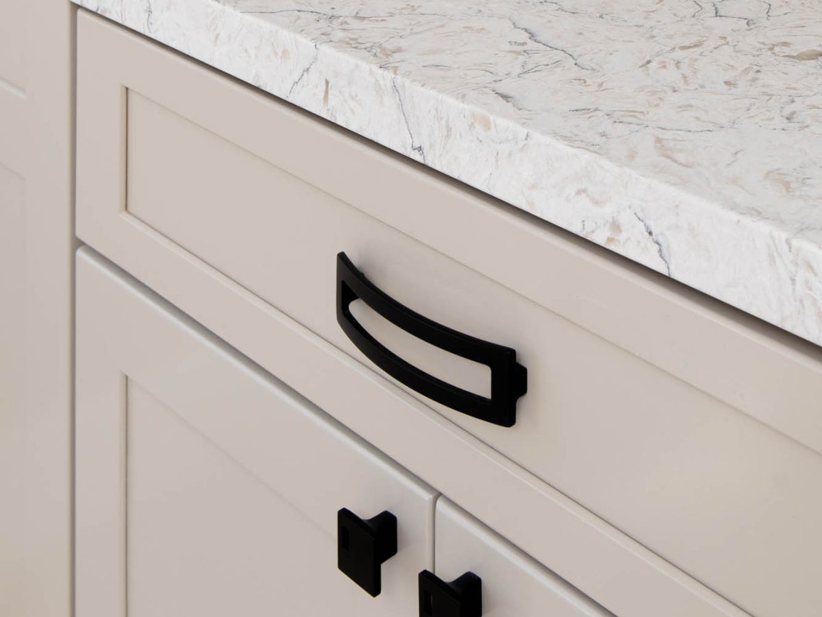 Primary bathroom with warm beige cabinetry and white veined quartz countertops — Reveal Interior Design Las Vegas