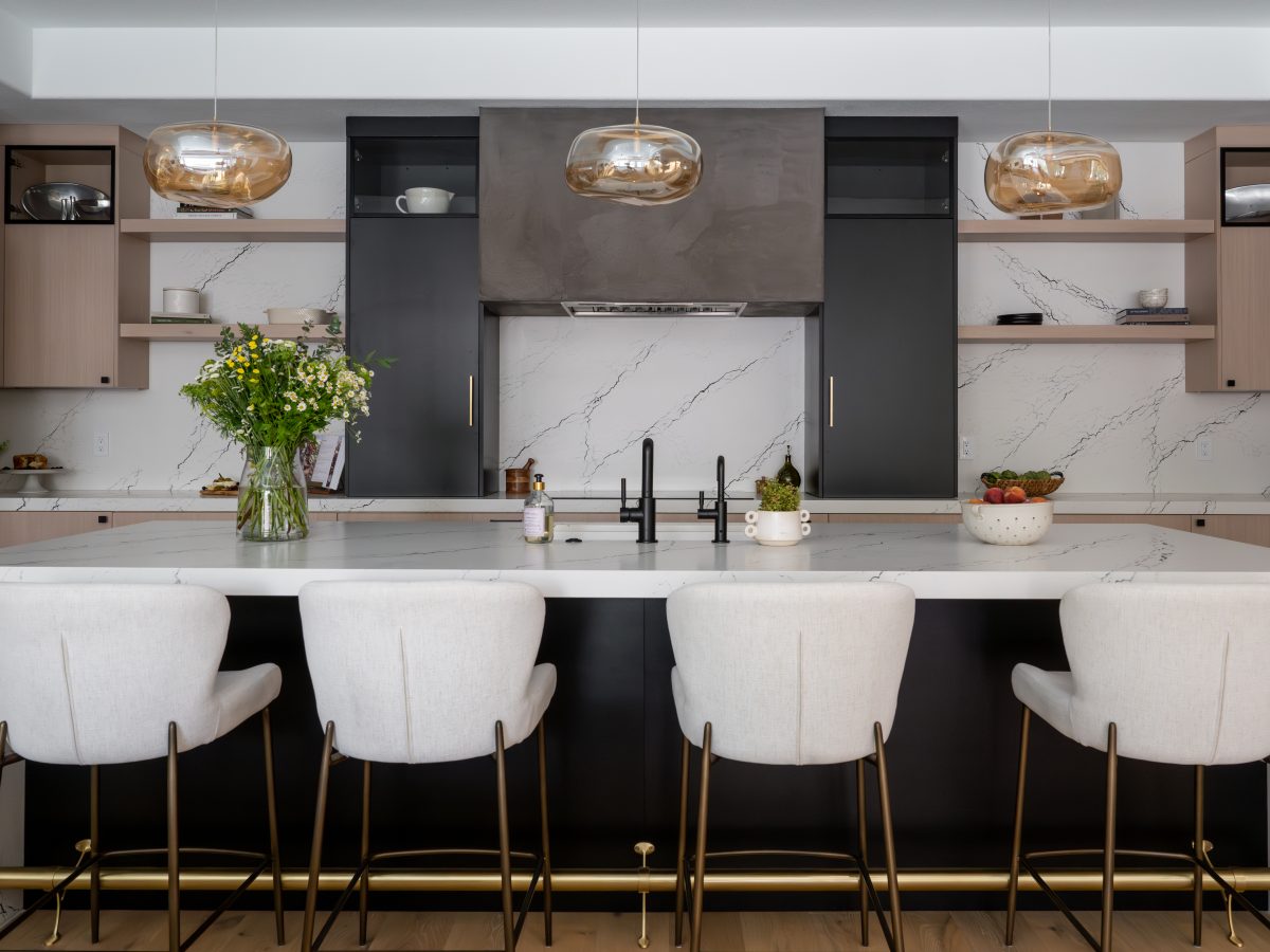 Contemporary kitchen with white quartz island, whitewashed oak cabinetry, and matte black accents — Reveal Interior Design Las Vegas