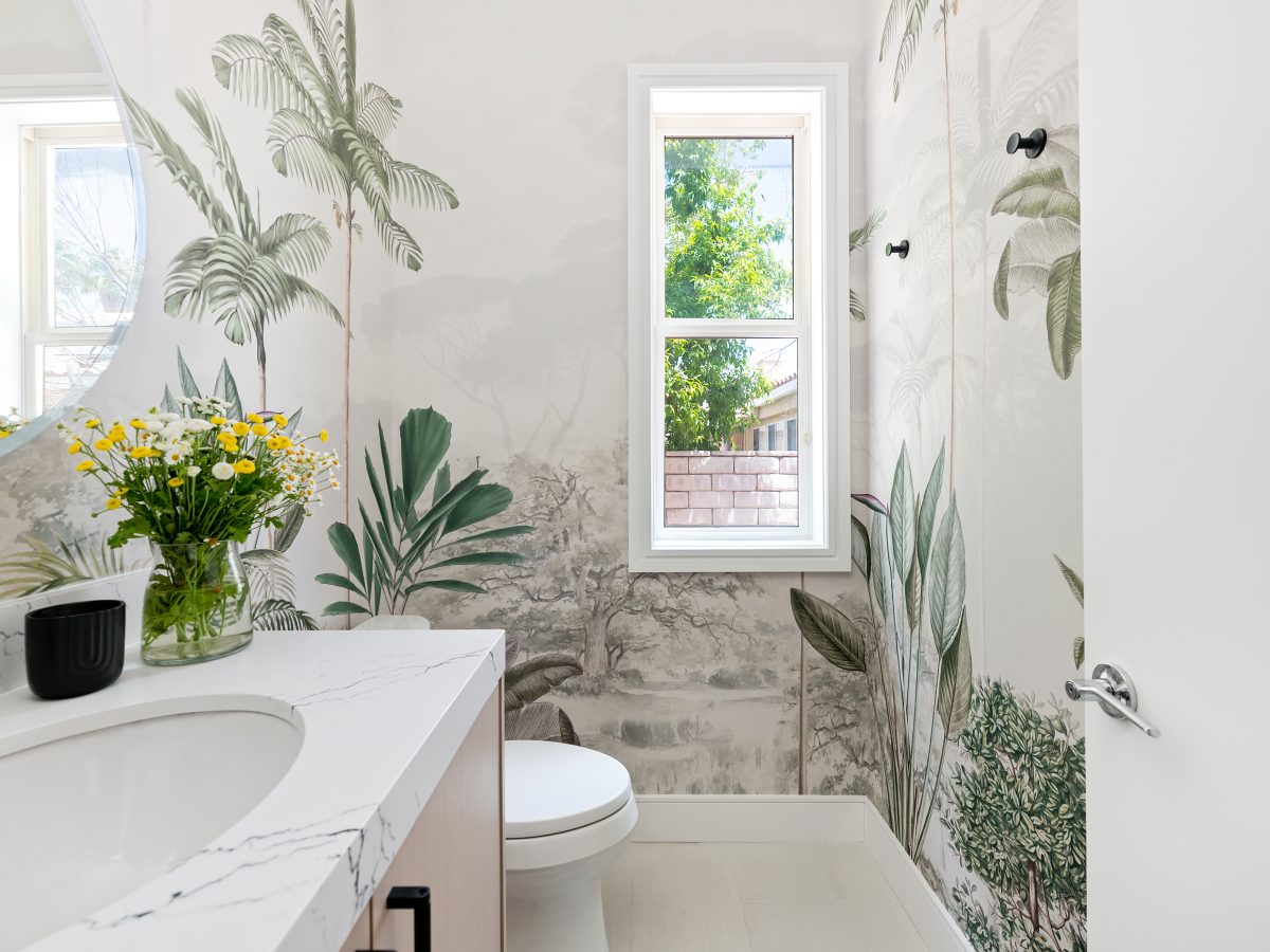 Powder bath with botanical mural wallcovering and stone countertops — Reveal Interior Design Las Vegas