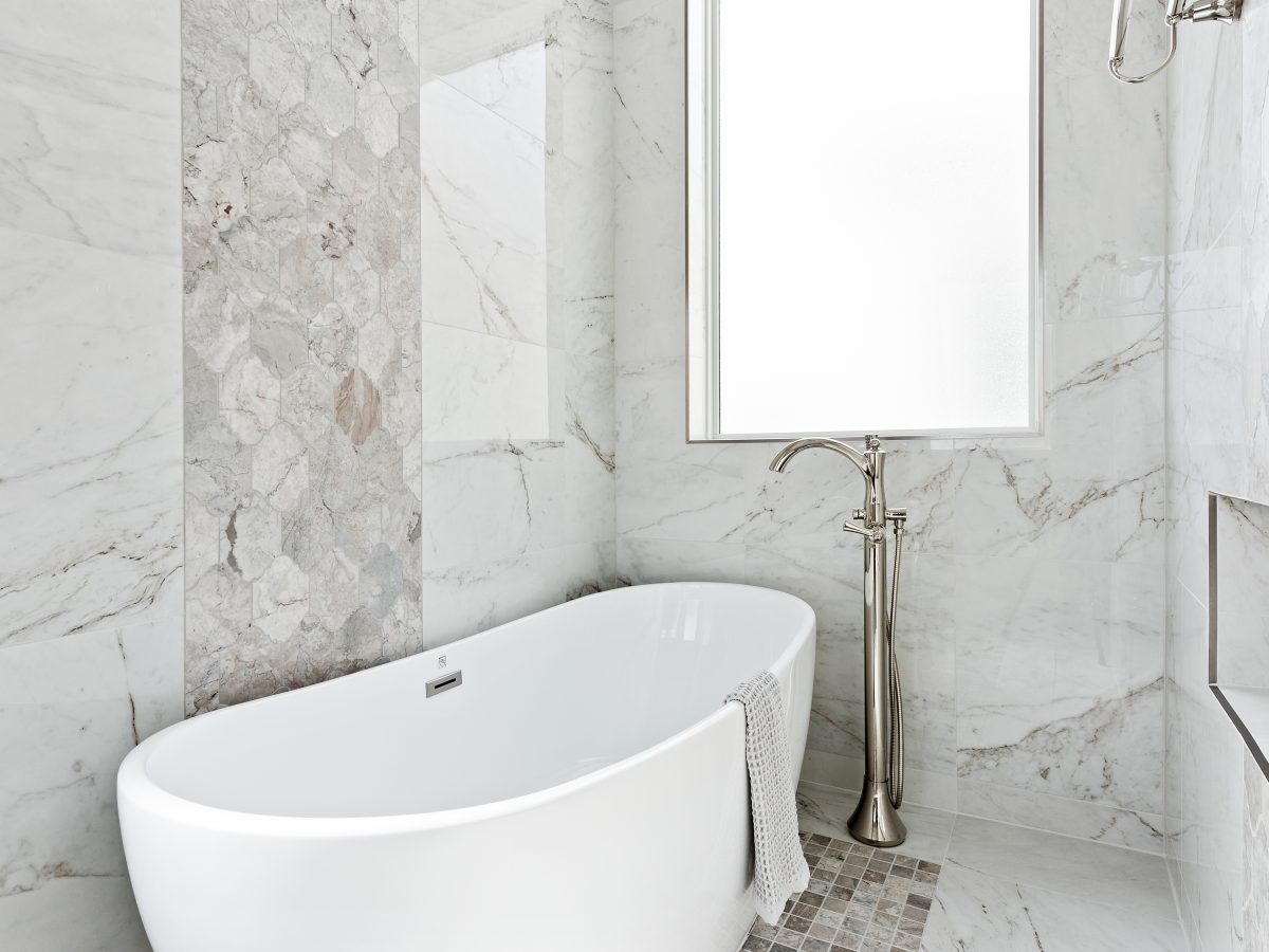 Transitional primary bathroom wet room with freestanding soaking tub and polished nickel floor-mount faucet — Reveal Interior Design Las Vegas