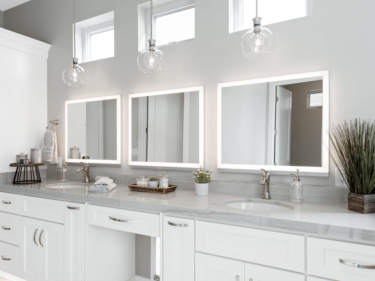 Transitional primary bathroom with Taj Mahal quartzite double vanity and LED medicine cabinets — Reveal Interior Design Las Vegas