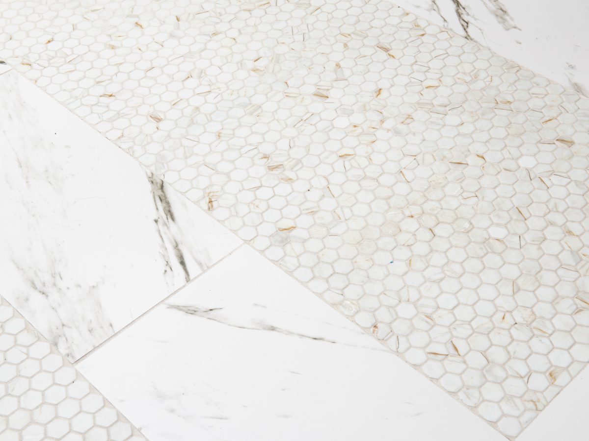 Primary bathroom with calacatta-look glass mosaic tile and calacatta porcelain floor — Reveal Interior Design Las Vegas